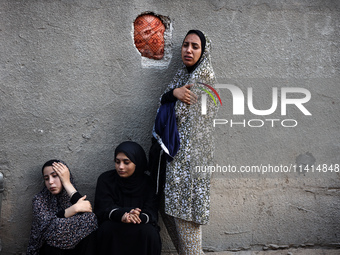 Palestinian women are reacting at the site of an Israeli strike on a house, in Nuseirat, central Gaza Strip, on July 17, 2024, amid the ongo...