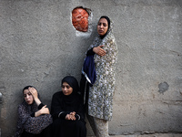 Palestinian women are reacting at the site of an Israeli strike on a house, in Nuseirat, central Gaza Strip, on July 17, 2024, amid the ongo...