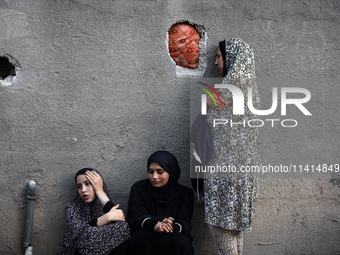 Palestinian women are reacting at the site of an Israeli strike on a house, in Nuseirat, central Gaza Strip, on July 17, 2024, amid the ongo...