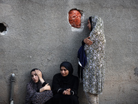 Palestinian women are reacting at the site of an Israeli strike on a house, in Nuseirat, central Gaza Strip, on July 17, 2024, amid the ongo...