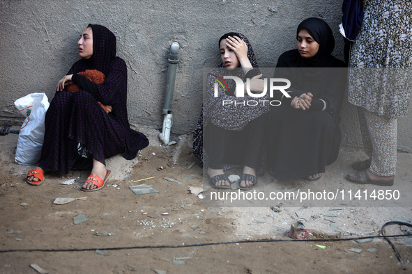 Palestinian women are reacting at the site of an Israeli strike on a house, in Nuseirat, central Gaza Strip, on July 17, 2024, amid the ongo...