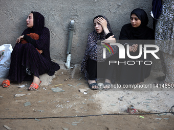 Palestinian women are reacting at the site of an Israeli strike on a house, in Nuseirat, central Gaza Strip, on July 17, 2024, amid the ongo...