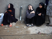 Palestinian women are reacting at the site of an Israeli strike on a house, in Nuseirat, central Gaza Strip, on July 17, 2024, amid the ongo...