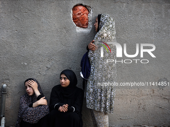 Palestinian women are reacting at the site of an Israeli strike on a house, in Nuseirat, central Gaza Strip, on July 17, 2024, amid the ongo...