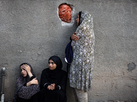 Palestinian women are reacting at the site of an Israeli strike on a house, in Nuseirat, central Gaza Strip, on July 17, 2024, amid the ongo...