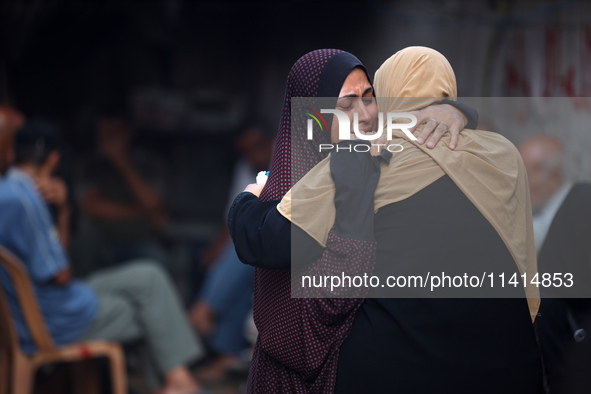 Palestinian women are reacting at the site of an Israeli strike on a house, in Nuseirat, central Gaza Strip, on July 17, 2024, amid the ongo...