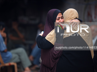 Palestinian women are reacting at the site of an Israeli strike on a house, in Nuseirat, central Gaza Strip, on July 17, 2024, amid the ongo...