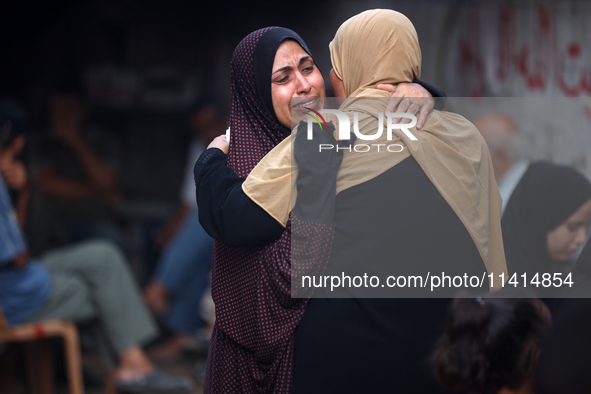 Palestinian women are reacting at the site of an Israeli strike on a house, in Nuseirat, central Gaza Strip, on July 17, 2024, amid the ongo...