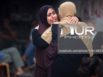 Palestinian women are reacting at the site of an Israeli strike on a house, in Nuseirat, central Gaza Strip, on July 17, 2024, amid the ongo...