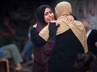 Palestinian women are reacting at the site of an Israeli strike on a house, in Nuseirat, central Gaza Strip, on July 17, 2024, amid the ongo...