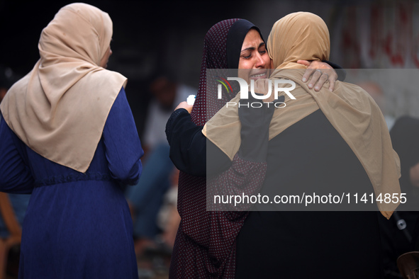 Palestinian women are reacting at the site of an Israeli strike on a house, in Nuseirat, central Gaza Strip, on July 17, 2024, amid the ongo...