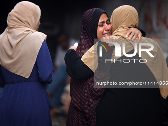 Palestinian women are reacting at the site of an Israeli strike on a house, in Nuseirat, central Gaza Strip, on July 17, 2024, amid the ongo...