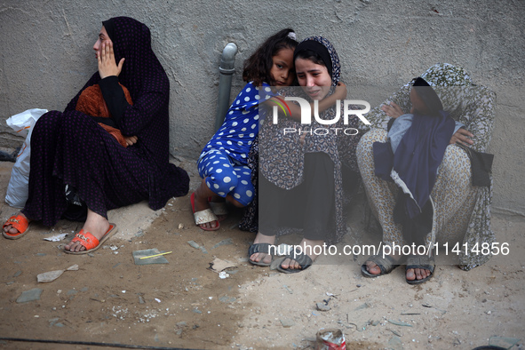 Palestinian women are reacting at the site of an Israeli strike on a house, in Nuseirat, central Gaza Strip, on July 17, 2024, amid the ongo...