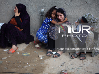 Palestinian women are reacting at the site of an Israeli strike on a house, in Nuseirat, central Gaza Strip, on July 17, 2024, amid the ongo...