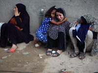 Palestinian women are reacting at the site of an Israeli strike on a house, in Nuseirat, central Gaza Strip, on July 17, 2024, amid the ongo...