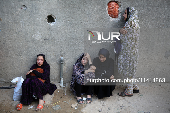 Palestinian women are reacting at the site of an Israeli strike on a house, in Nuseirat, central Gaza Strip, on July 17, 2024, amid the ongo...