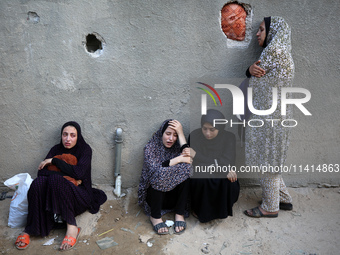 Palestinian women are reacting at the site of an Israeli strike on a house, in Nuseirat, central Gaza Strip, on July 17, 2024, amid the ongo...