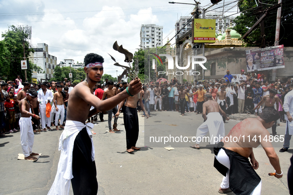 Shiite Muslims are flagellating themselves during a procession to mark Ashura in South Kolkata, India, on July 17, 2024. Ashura is the 10th...