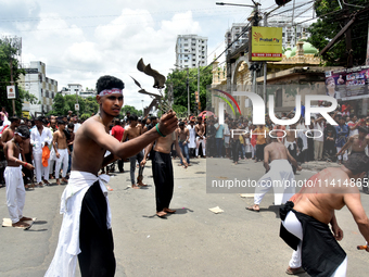 Shiite Muslims are flagellating themselves during a procession to mark Ashura in South Kolkata, India, on July 17, 2024. Ashura is the 10th...