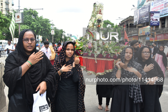 A Shiite Muslim woman is breaking down as she mourns during a procession to mark Ashura, in south Kolkata, India, on July 17, 2024. Ashura i...