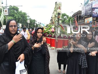 A Shiite Muslim woman is breaking down as she mourns during a procession to mark Ashura, in south Kolkata, India, on July 17, 2024. Ashura i...