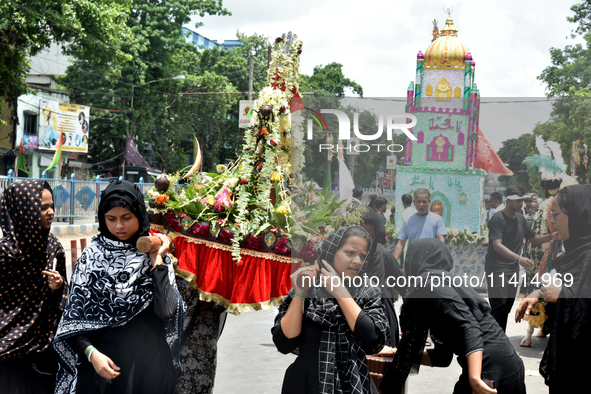 A Shiite Muslim woman is breaking down as she mourns during a procession to mark Ashura, in south Kolkata, India, on July 17, 2024. Ashura i...