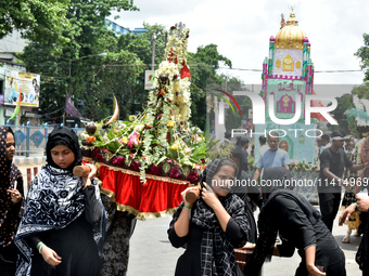 A Shiite Muslim woman is breaking down as she mourns during a procession to mark Ashura, in south Kolkata, India, on July 17, 2024. Ashura i...