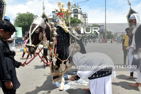 A Shiite Muslim woman is breaking down as she mourns during a procession to mark Ashura, in south Kolkata, India, on July 17, 2024. Ashura i...