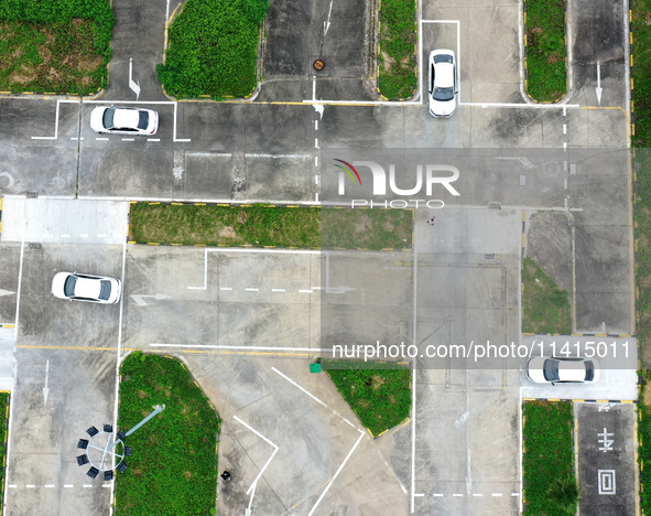 A trainee is practicing driving on the training ground of Jindun Driver Training School in Chaohu City, Anhui province, China, on July 17, 2...