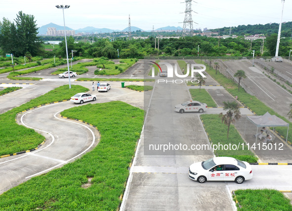 A trainee is practicing driving on the training ground of Jindun Driver Training School in Chaohu City, Anhui province, China, on July 17, 2...