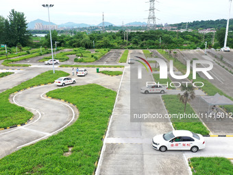 A trainee is practicing driving on the training ground of Jindun Driver Training School in Chaohu City, Anhui province, China, on July 17, 2...