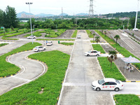 A trainee is practicing driving on the training ground of Jindun Driver Training School in Chaohu City, Anhui province, China, on July 17, 2...