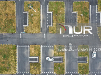 A trainee is practicing driving on the training ground of Jindun Driver Training School in Chaohu City, Anhui province, China, on July 17, 2...