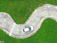 A trainee is practicing driving on the training ground of Jindun Driver Training School in Chaohu City, Anhui province, China, on July 17, 2...