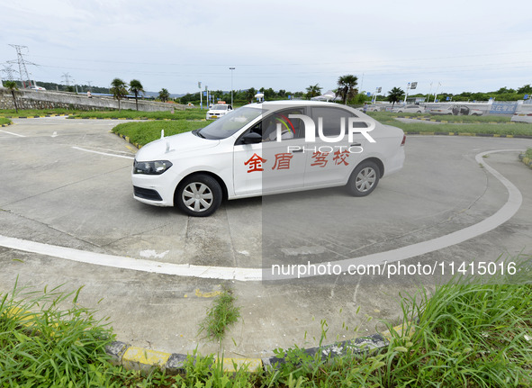 A trainee is practicing driving on the training ground of Jindun Driver Training School in Chaohu City, Anhui province, China, on July 17, 2...