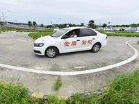 A trainee is practicing driving on the training ground of Jindun Driver Training School in Chaohu City, Anhui province, China, on July 17, 2...