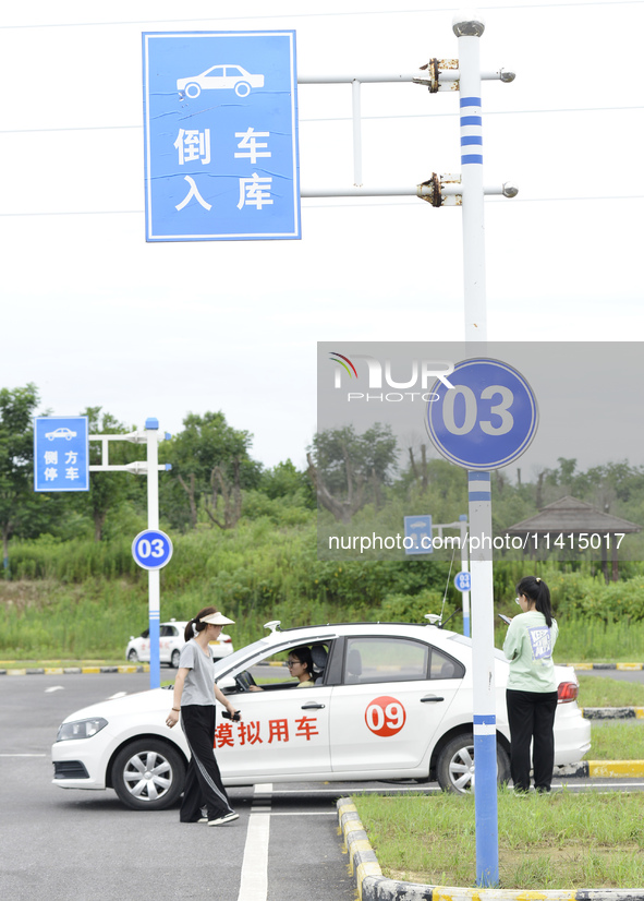 A trainee is practicing driving on the training ground of Jindun Driver Training School in Chaohu City, Anhui province, China, on July 17, 2...