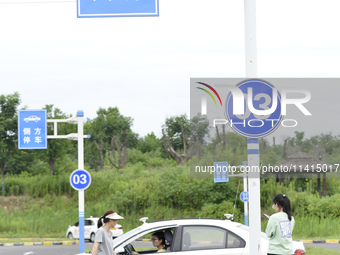 A trainee is practicing driving on the training ground of Jindun Driver Training School in Chaohu City, Anhui province, China, on July 17, 2...