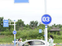 A trainee is practicing driving on the training ground of Jindun Driver Training School in Chaohu City, Anhui province, China, on July 17, 2...