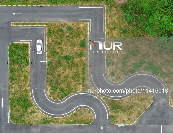 A trainee is practicing driving on the training ground of Jindun Driver Training School in Chaohu City, Anhui province, China, on July 17, 2...