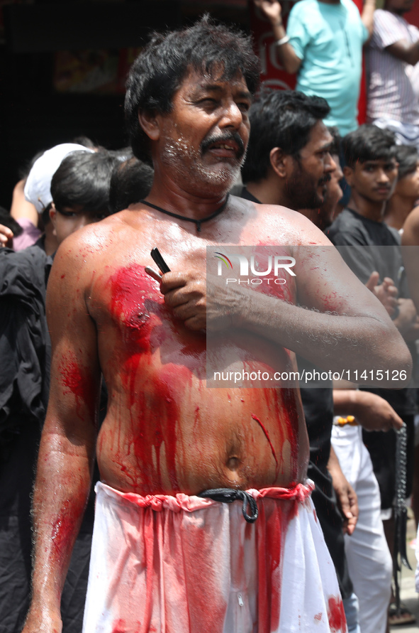 A Shi'ite Muslim is flagellating himself during a Muharram procession marking Ashura in Kolkata, India, on July 17, 2024. 