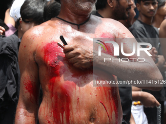 A Shi'ite Muslim is flagellating himself during a Muharram procession marking Ashura in Kolkata, India, on July 17, 2024. (