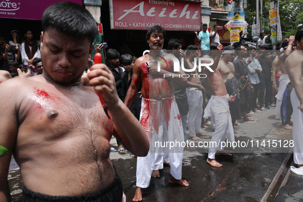 Shi'ite Muslims are flagellating themselves during a Muharram procession marking Ashura, in Kolkata, India, on July 17, 2024. 