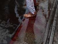 A Shi'ite Muslim is standing on a road after flagellating himself during a Muharram procession marking Ashura, in Kolkata, India, on July 17...