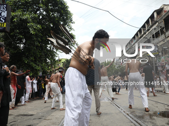 Shi'ite Muslims are flagellating themselves during a Muharram procession marking Ashura, in Kolkata, India, on July 17, 2024. (