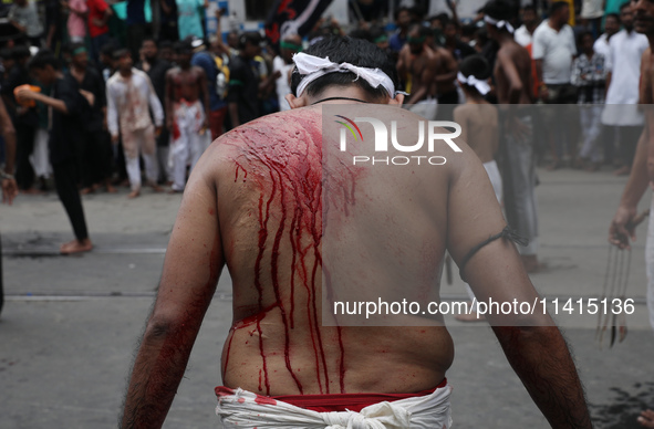 A Shi'ite Muslim is bleeding after flagellating himself during a Muharram procession marking Ashura, in Kolkata, India, on July 17, 2024. 