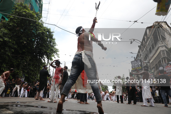 Shi'ite Muslims are flagellating themselves during a Muharram procession marking Ashura, in Kolkata, India, on July 17, 2024. 