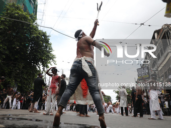 Shi'ite Muslims are flagellating themselves during a Muharram procession marking Ashura, in Kolkata, India, on July 17, 2024. (