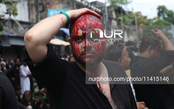 A Shi'ite Muslim man is mourning after flagellating himself during a Muharram procession marking Ashura, in Kolkata, India, on July 17, 2024...