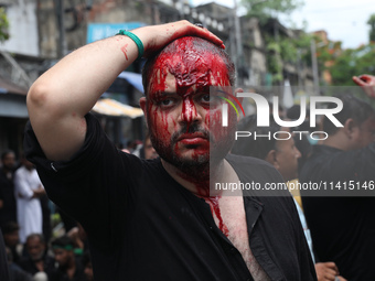 A Shi'ite Muslim man is mourning after flagellating himself during a Muharram procession marking Ashura, in Kolkata, India, on July 17, 2024...